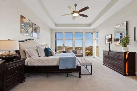 a kitchen with stainless steel appliances kitchen island granite countertop a dining table chairs and wooden floor