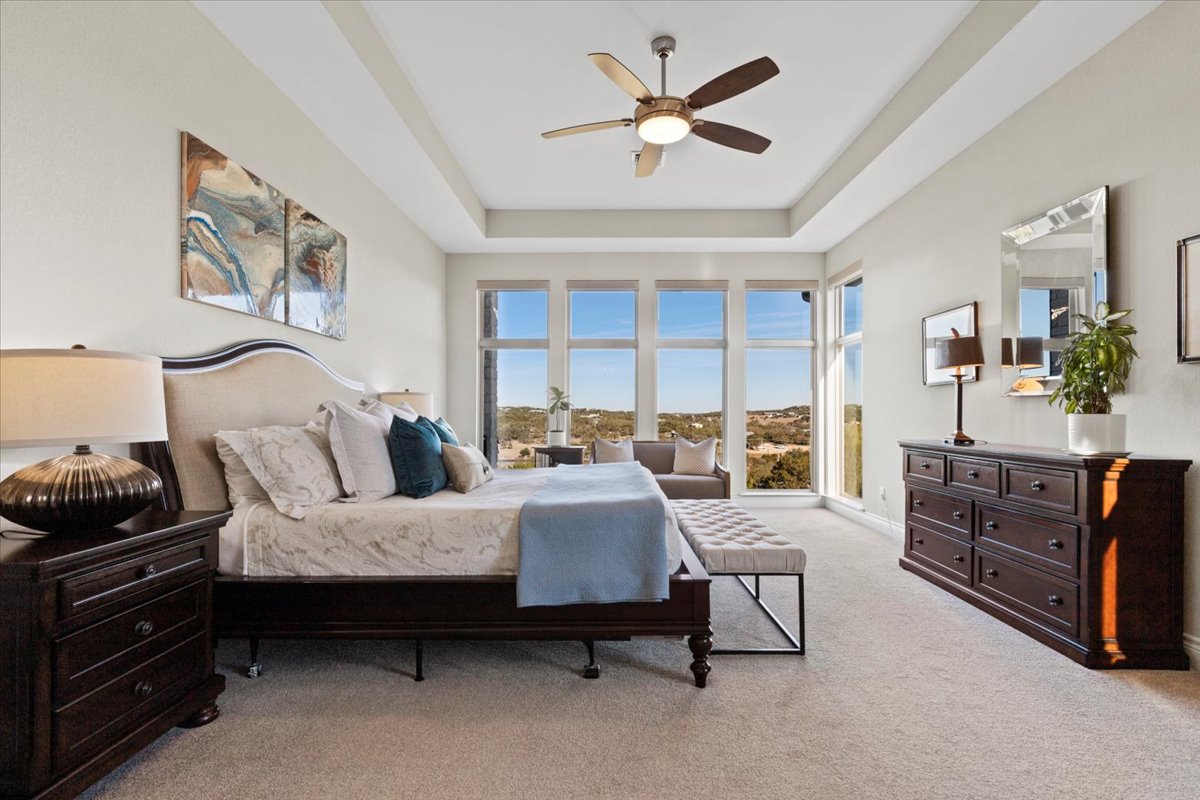 17825 Windecker Cove Dripping Springs, TX 78620 - Photo 5 of 39 a bedroom with furniture and large windows