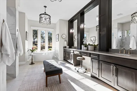 a bedroom with furniture and large windows