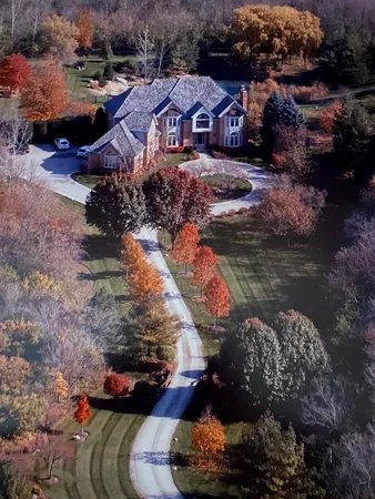 a aerial view of a house with a yard basket ball court and outdoor seating