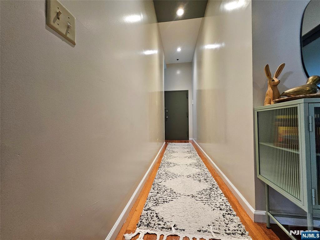 9 East 18th Street, Unit 3A Bayonne, NJ 07002 - Photo 4 of 4 a view of hallway with mirror
