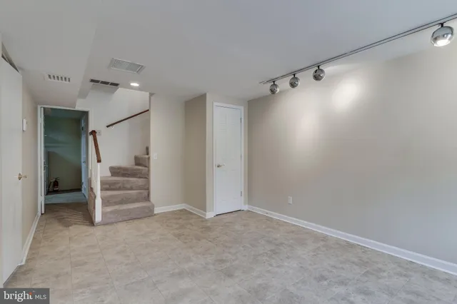 a view of an empty walk in closet and a bathroom