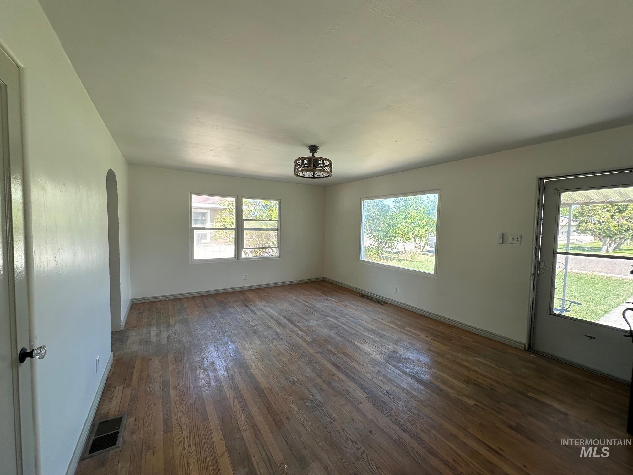 264 Southwest 10th Avenue Ontario, OR 97914 - Photo 25 of 26 Unfurnished living room with hardwood / wood-style floors and arched walkways