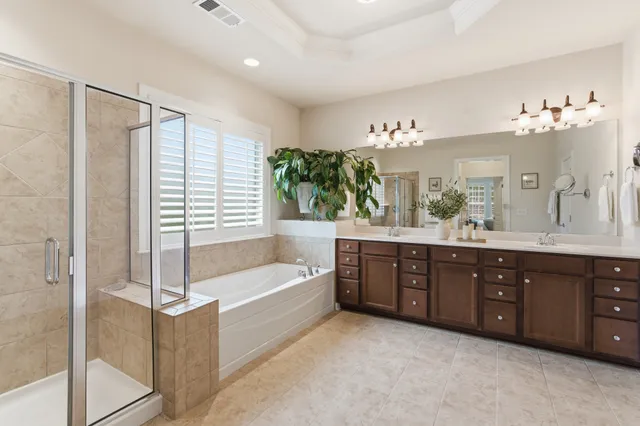 a bathroom with a tub sink and mirror
