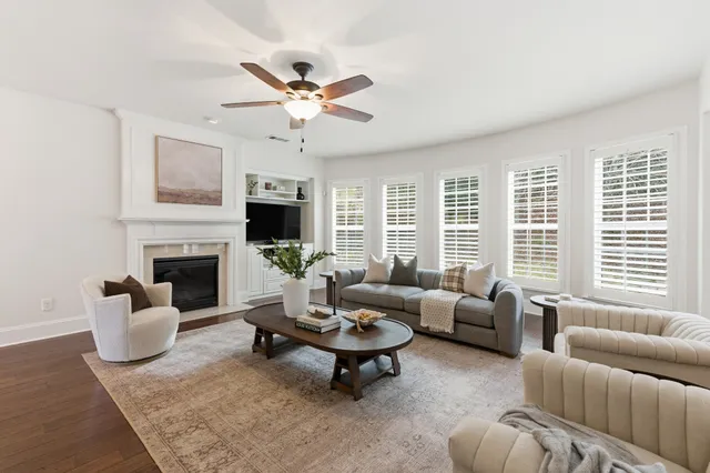 a living room with furniture a fireplace and a flat screen tv
