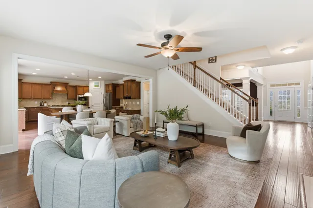 a living room with furniture and a chandelier