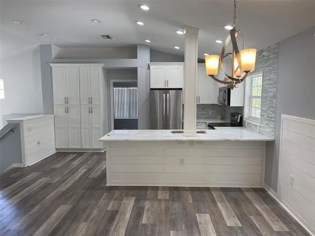 a view of kitchen with cabinets and wooden floor