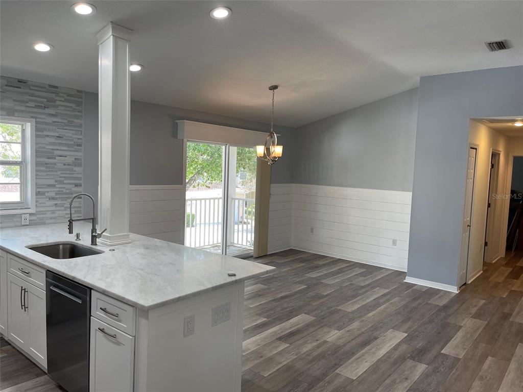 6412 Rosefinch Court, Unit 201 Lakewood Ranch, FL 34202 - Photo 7 of 14 a kitchen with a sink and large mirror