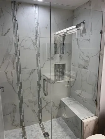 a bathroom with a granite countertop toilet a sink and bathtub