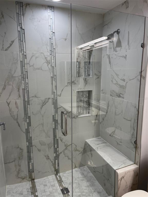 6412 Rosefinch Court, Unit 201 Lakewood Ranch, FL 34202 - Photo 8 of 14 a bathroom with a shower and toilet