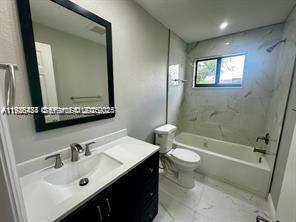 303 Northwest 7th Street, Unit 12 Hallandale Beach, FL 33009 - Photo 11 of 18 a bathroom with a sink and a mirror