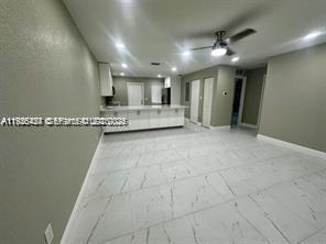 303 Northwest 7th Street, Unit 12 Hallandale Beach, FL 33009 - Photo 13 of 18 a view of a livingroom with kitchen