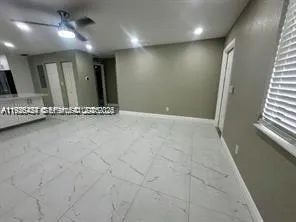 a kitchen with stainless steel appliances granite countertop a sink and a refrigerator