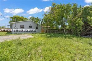 303 Northwest 7th Street, Unit 12 Hallandale Beach, FL 33009 - Photo 15 of 18 a house view with a garden space