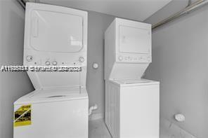 303 Northwest 7th Street, Unit 12 Hallandale Beach, FL 33009 - Photo 7 of 18 a utility room with dryer and washer