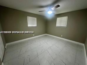 303 Northwest 7th Street, Unit 12 Hallandale Beach, FL 33009 - Photo 10 of 18 a view of a hall with windows