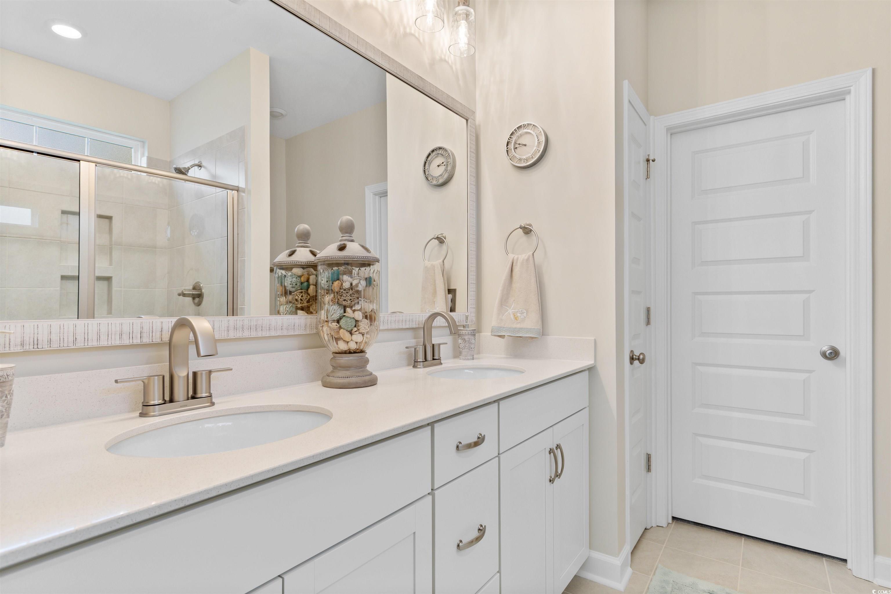 240 Sundew Loop Little River, SC 29566 - Photo 16 of 40 Full bathroom with double vanity, a stall shower, and tile patterned floors