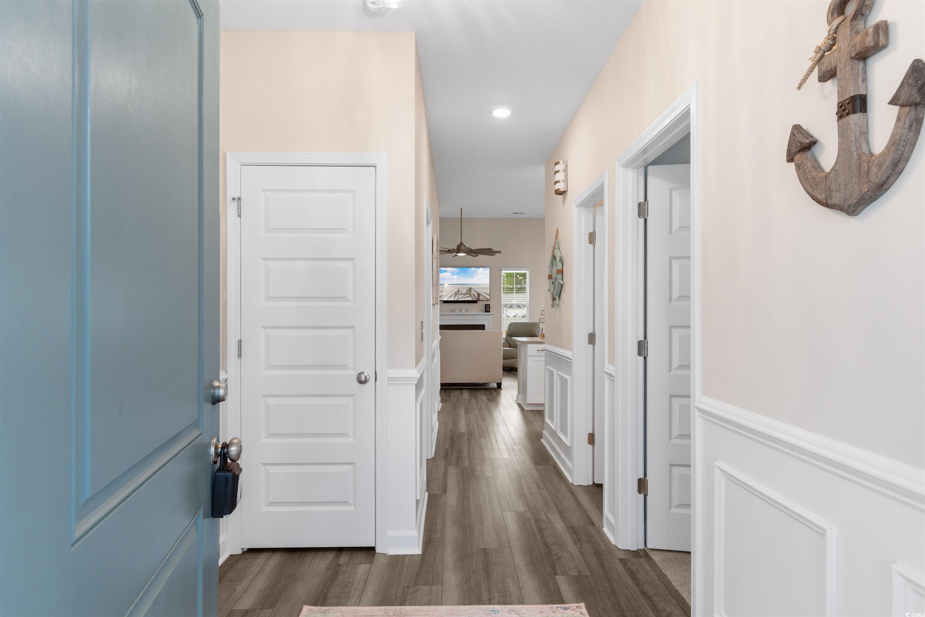 240 Sundew Loop Little River, SC 29566 - Photo 3 of 40 Hallway featuring a wainscoted wall, dark wood finished floors, recessed lighting, and a decorative wall