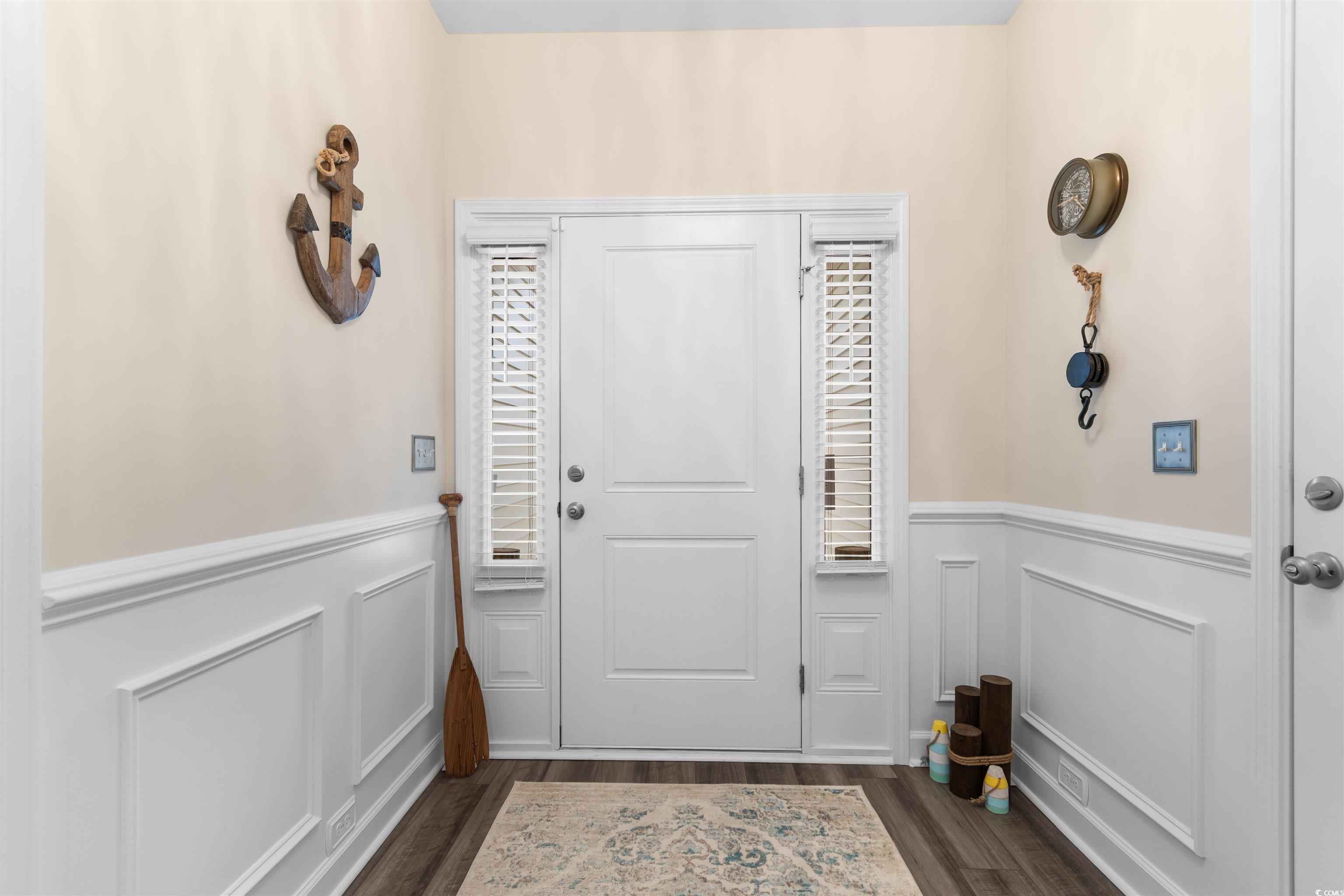 240 Sundew Loop Little River, SC 29566 - Photo 4 of 40 Entryway featuring wainscoting, dark wood-type flooring, and a decorative wall