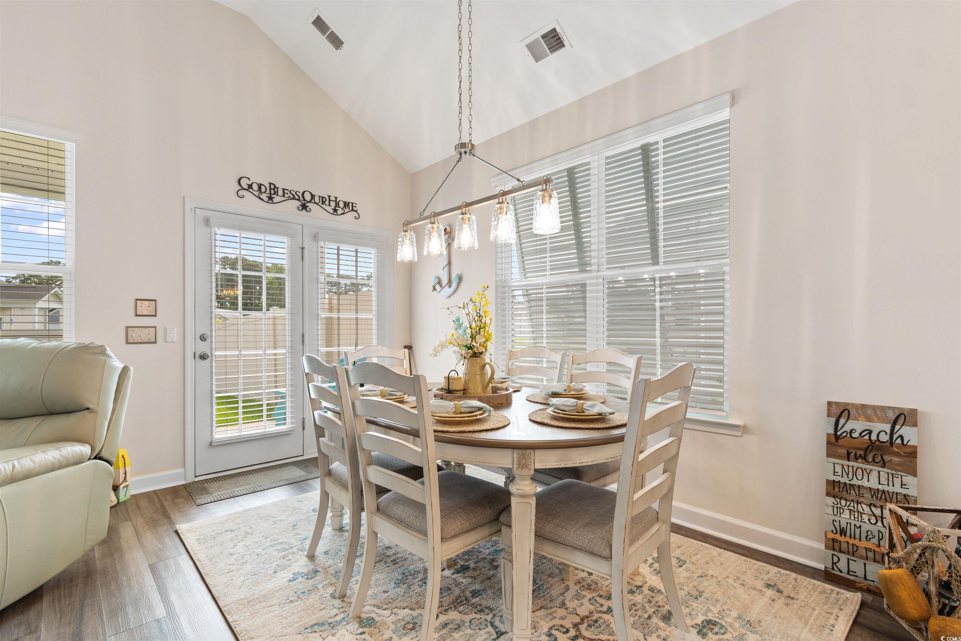 240 Sundew Loop Little River, SC 29566 - Photo 10 of 40 Dining area with wood finished floors and high vaulted ceiling