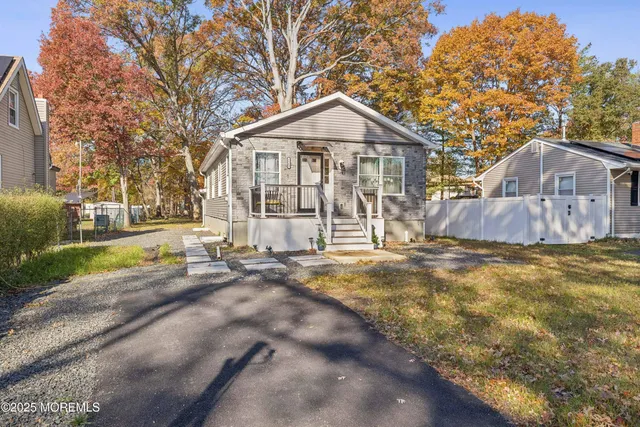 a view of a large house with a yard and large tree