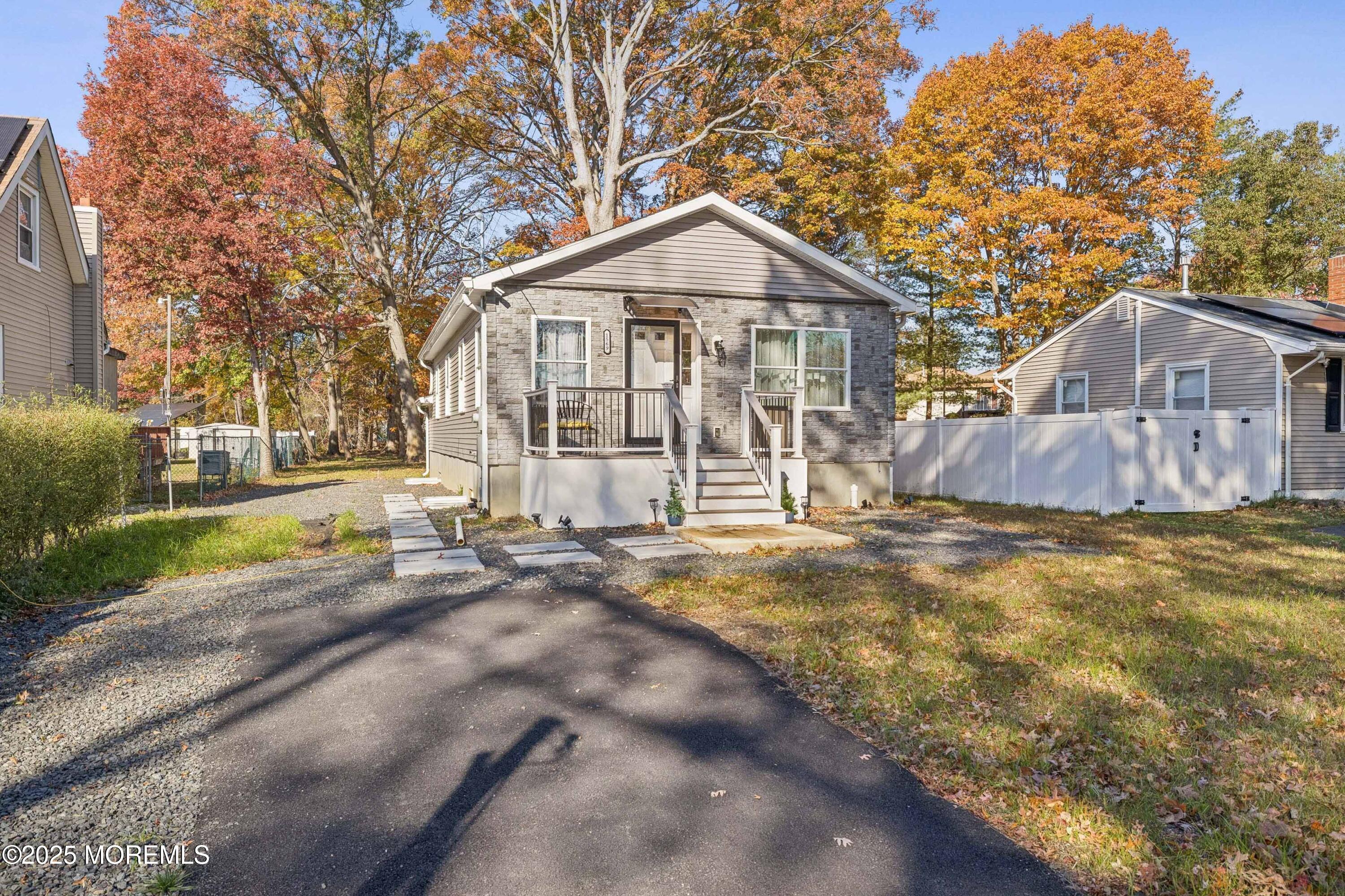 a view of a large house with a yard and large tree