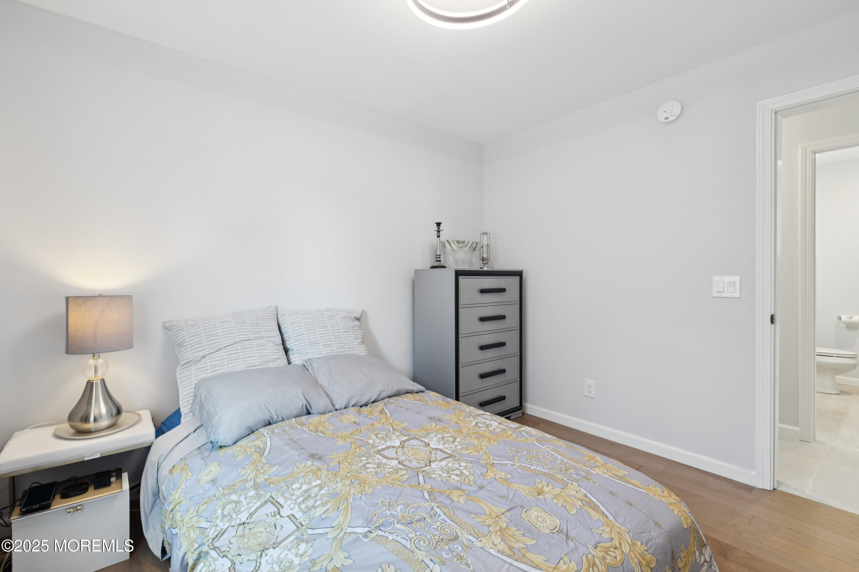 1569 Holly Road North Brunswick, NJ 08902 - Photo 15 of 29 a bedroom with a bed and a lamp