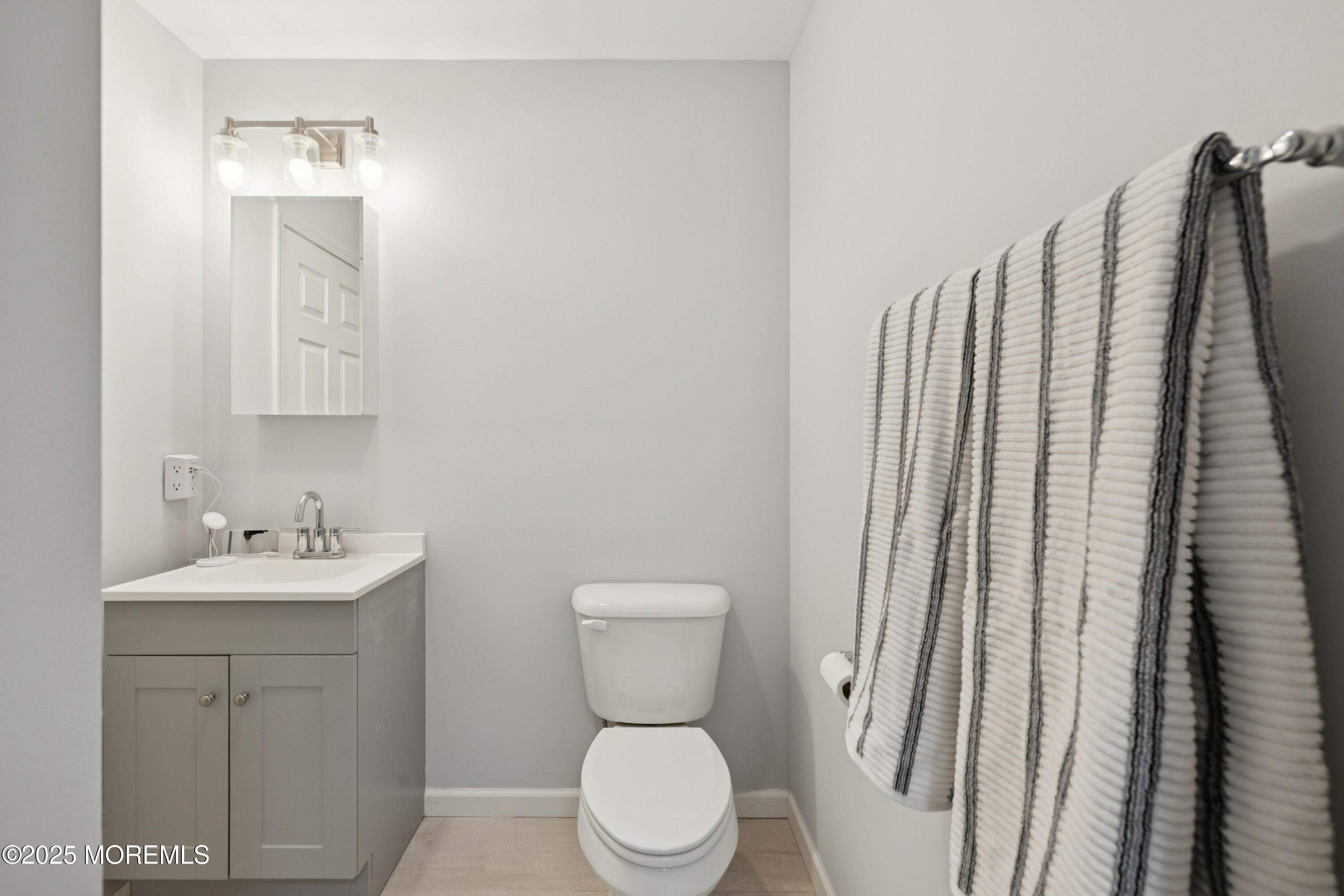 1569 Holly Road North Brunswick, NJ 08902 - Photo 20 of 29 a bathroom with a toilet sink and mirror