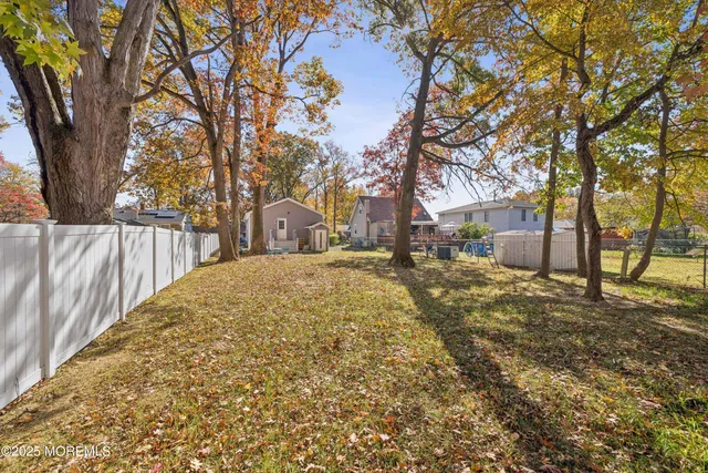 a white house that has a tree in front of it