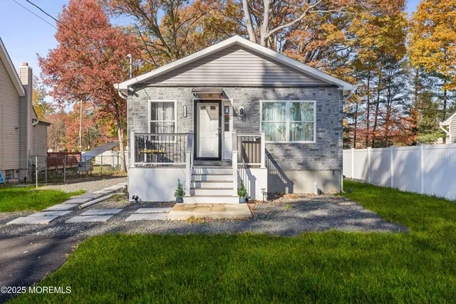 a kitchen with stainless steel appliances a stove a sink a microwave a refrigerator and cabinets