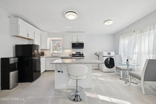 a kitchen with a sink stainless steel appliances and cabinets