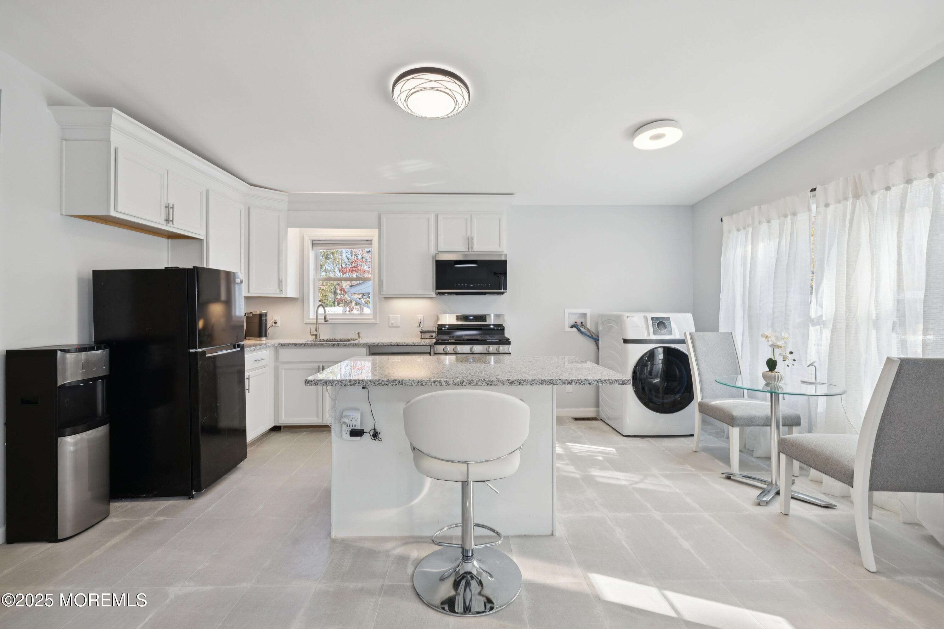 1569 Holly Road North Brunswick, NJ 08902 - Photo 5 of 29 a kitchen with a sink a stove a refrigerator cabinets and chairs