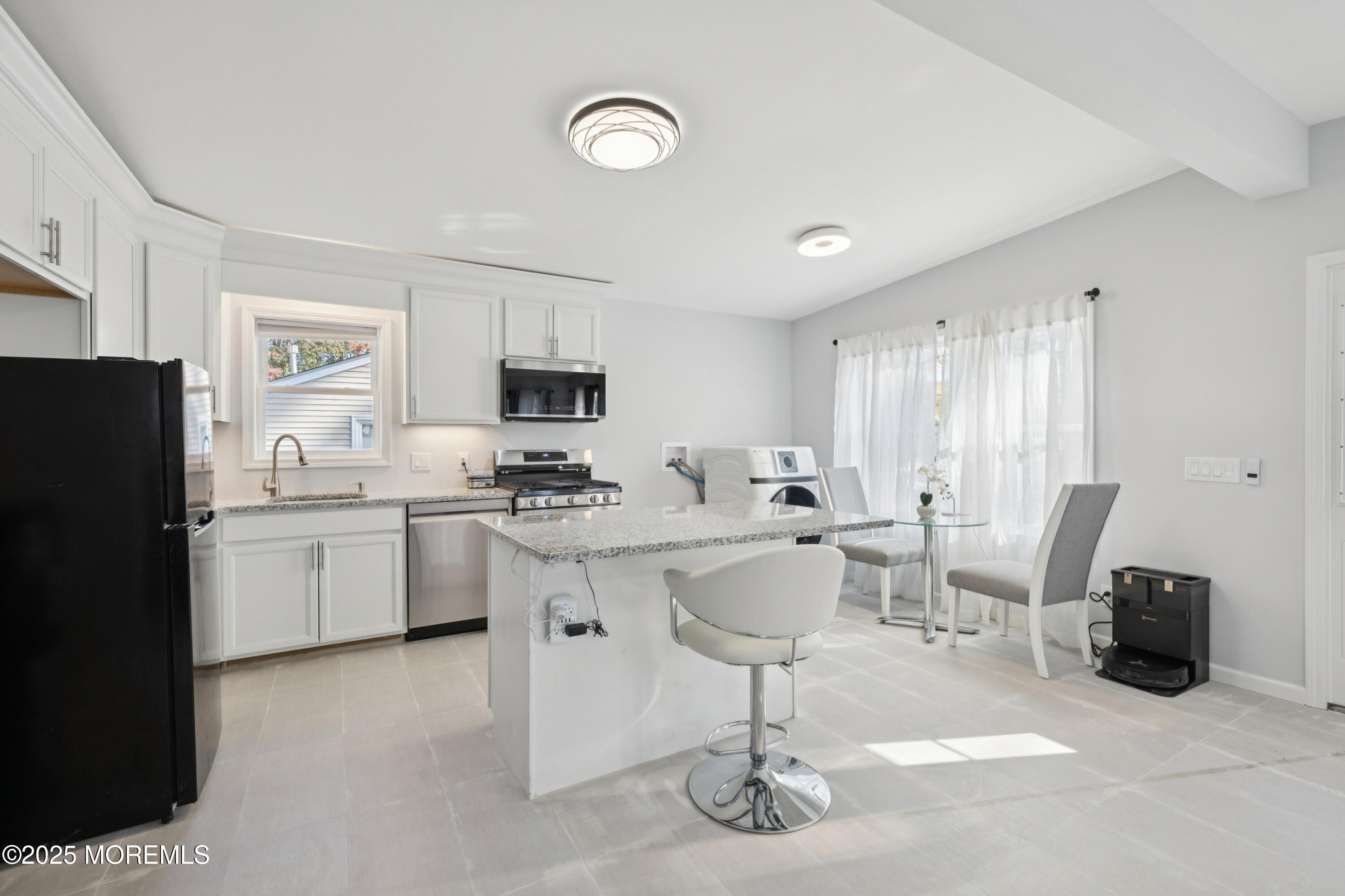 1569 Holly Road North Brunswick, NJ 08902 - Photo 6 of 29 a kitchen with a sink stainless steel appliances and cabinets