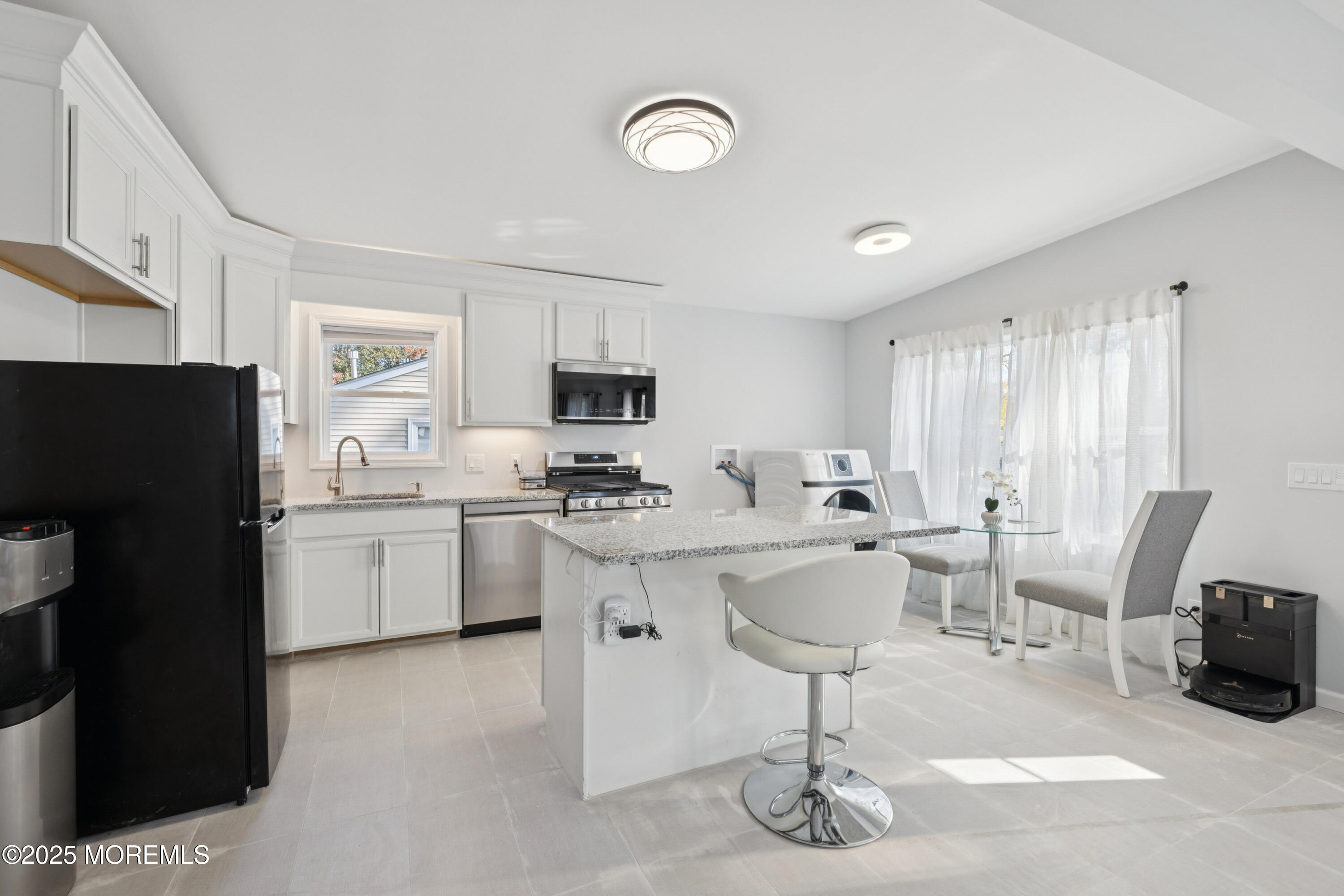 1569 Holly Road North Brunswick, NJ 08902 - Photo 7 of 29 a kitchen with cabinets and chairs