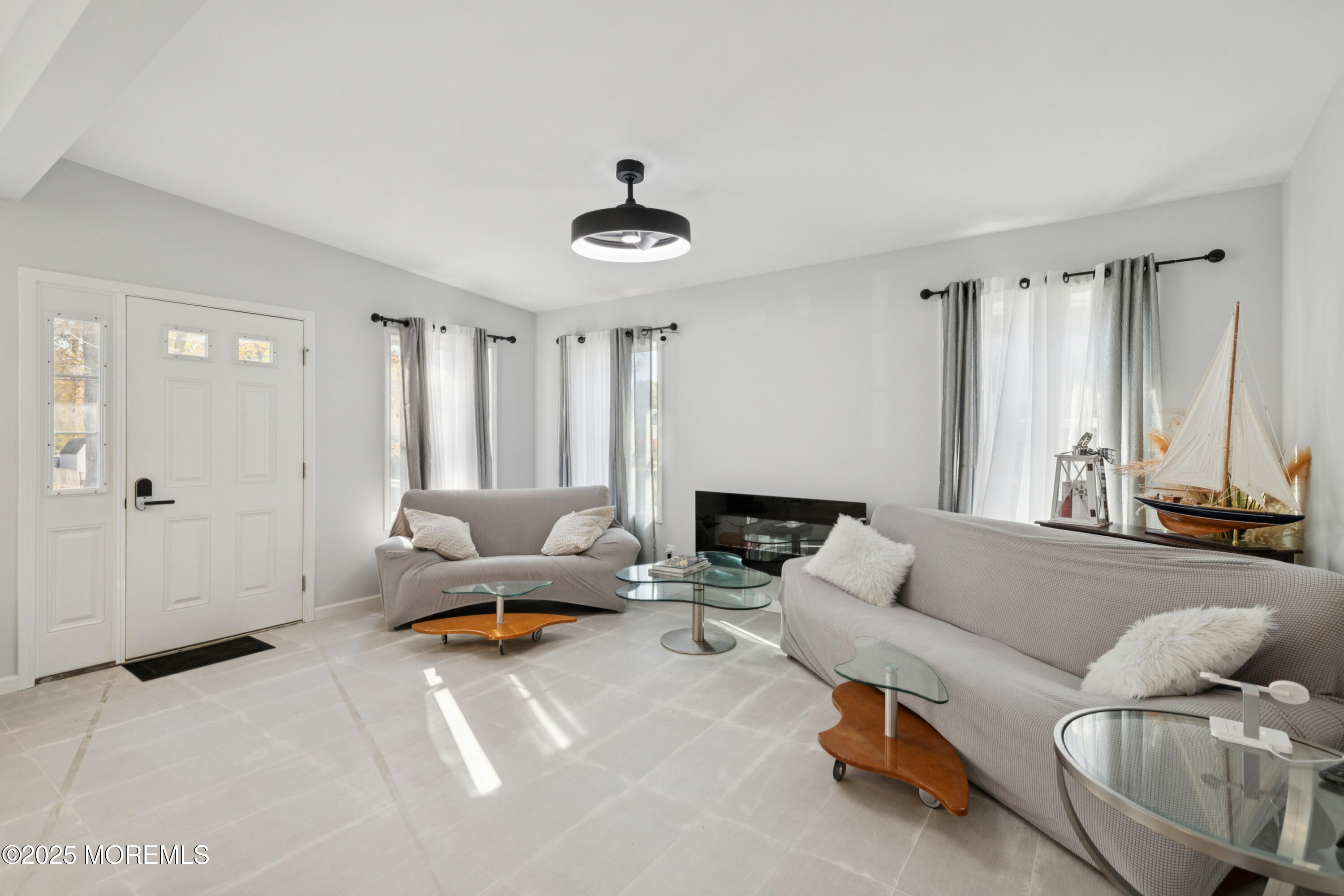 1569 Holly Road North Brunswick, NJ 08902 - Photo 10 of 29 a living room with furniture and a large window