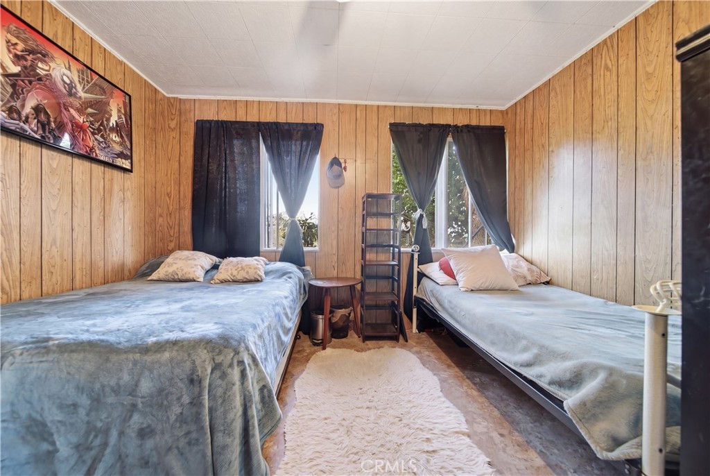 60153 Stearman Road Landers, CA 92285 - Photo 14 of 26 a bedroom with bed and window