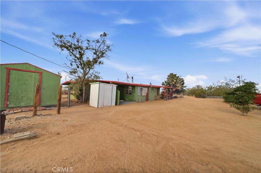 60153 Stearman Road Landers, CA 92285 - Photo 17 of 26 a view of a house with a yard and potted plants