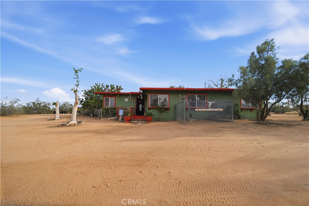 60153 Stearman Road Landers, CA 92285 - Photo 18 of 26 a front view of a house with a yard and a garage