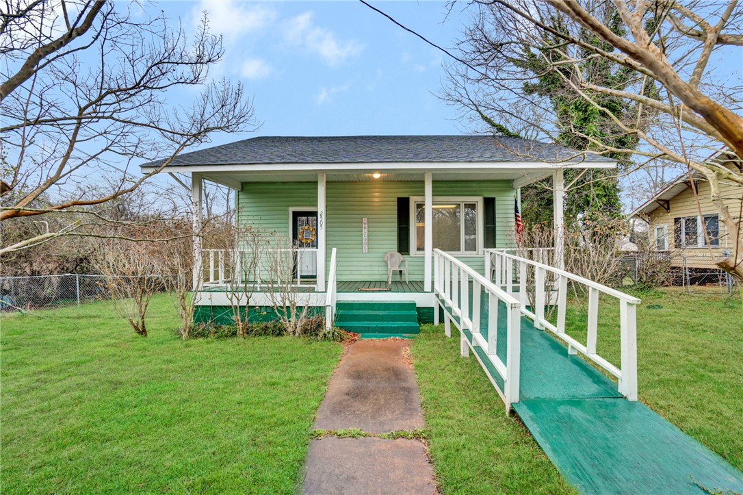 2505 East Brown Street Seneca, SC 29678 - Photo 1 of 43 This charming bungalow offers a welcoming facade with a convenient ramp leading to the front porch.