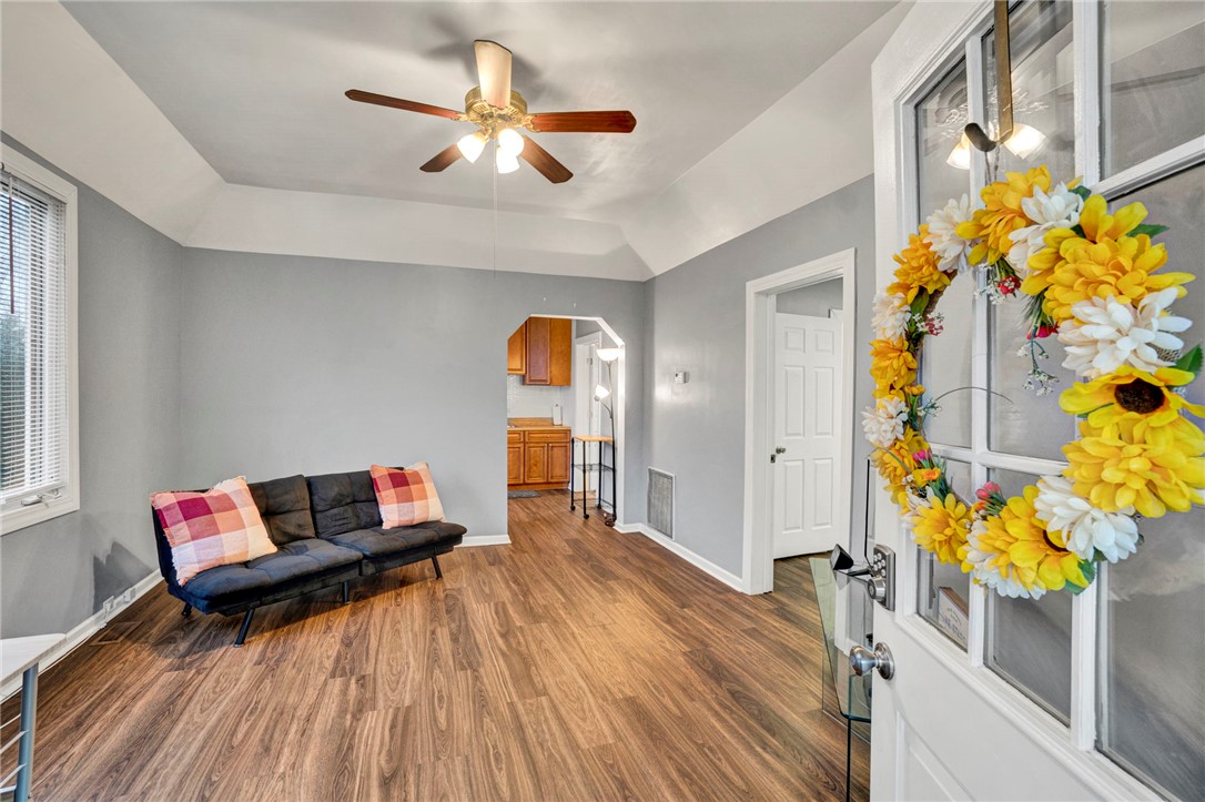 2505 East Brown Street Seneca, SC 29678 - Photo 9 of 43 This inviting living space features warm flooring, a tray ceiling, and a bright entryway.