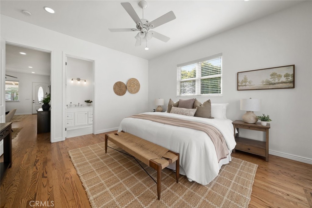 2265 Broad Street San Luis Obispo, CA 93401 - Photo 18 of 39 a spacious bedroom with a bed and a chandelier