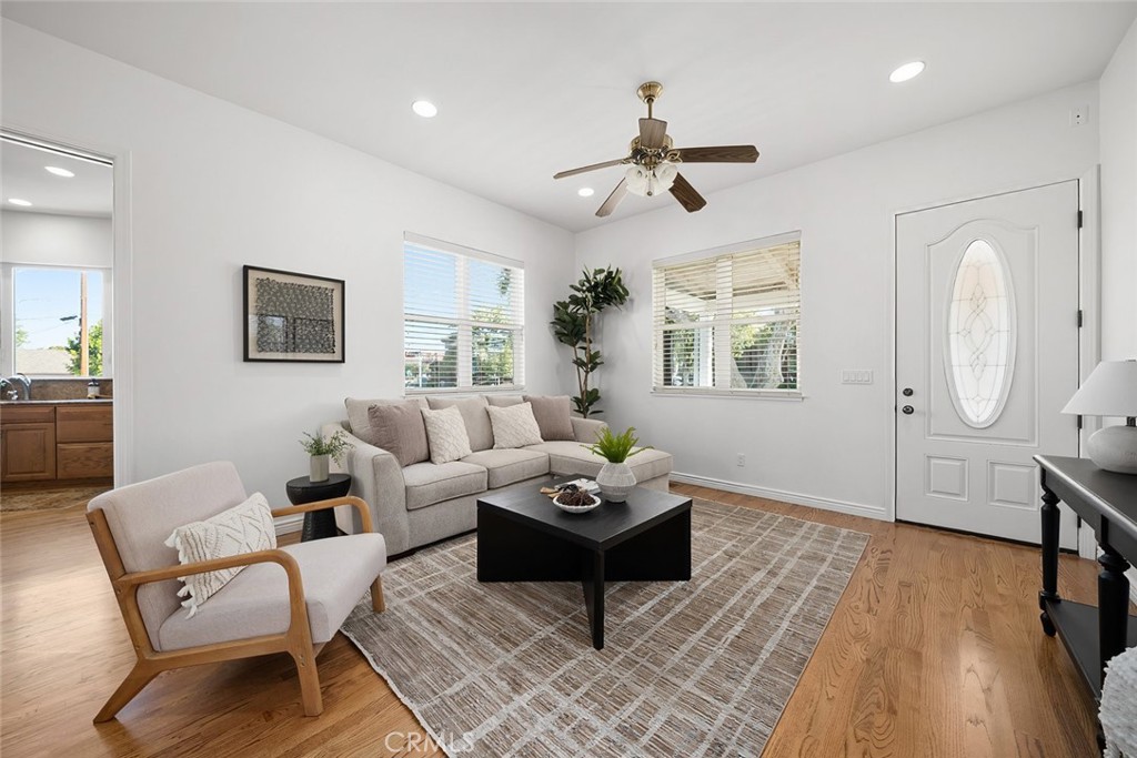 2265 Broad Street San Luis Obispo, CA 93401 - Photo 2 of 39 a living room with furniture a wooden floor and a chandelier