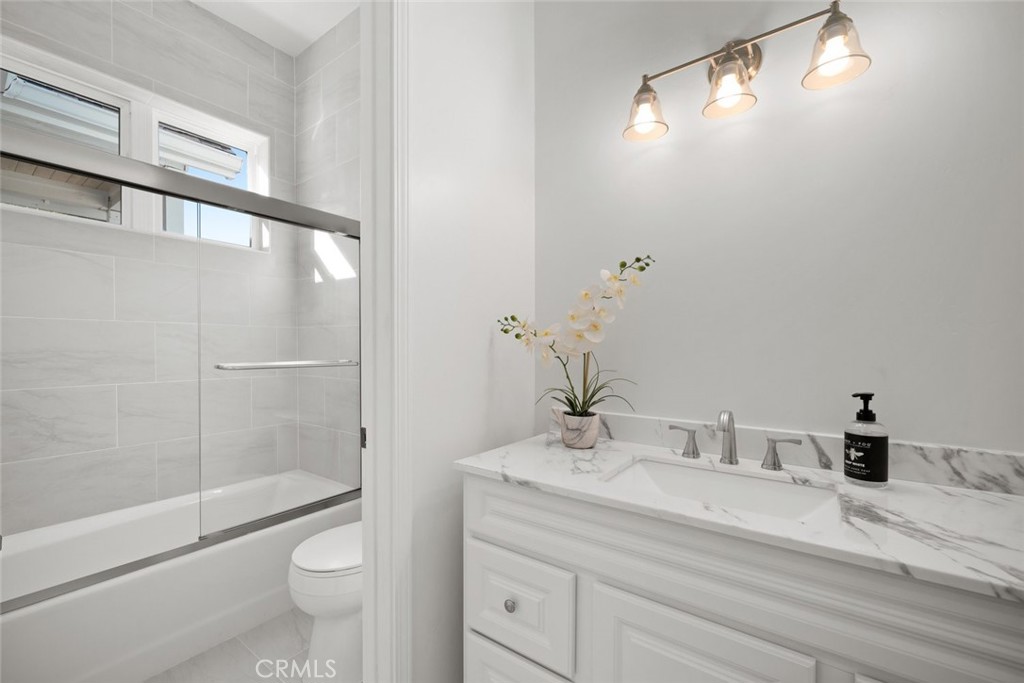2265 Broad Street San Luis Obispo, CA 93401 - Photo 29 of 39 a bathroom with a granite countertop sink toilet and shower