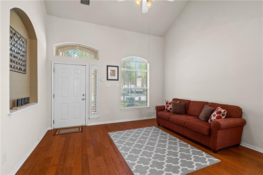 3508 Bratton Ridge Crossing Austin, TX 78728 - Photo 9 of 18 Enter into a living space showcasing beautiful hardwood flooring and soaring ceilings.