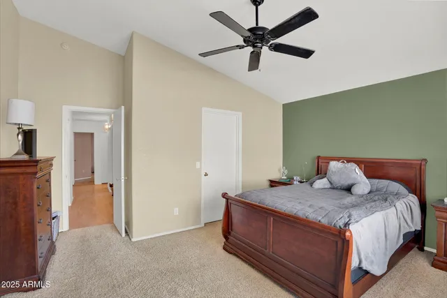 a bedroom with a bed and a large window