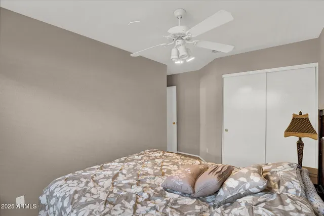 a bedroom with a bed and a tv