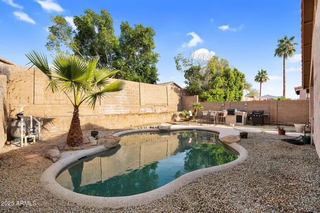 swimming pool view with a seating space