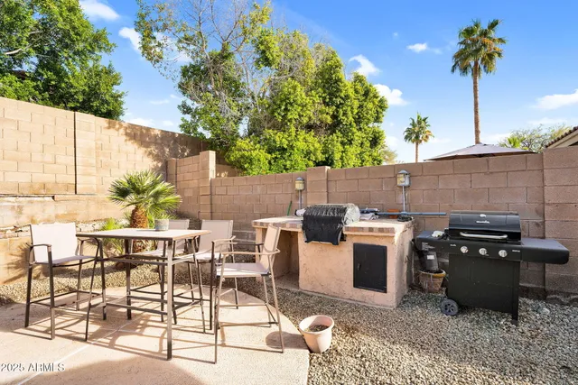 a view of a swimming pool with a lounge chairs in a patio