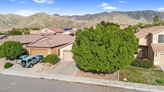 an aerial view of a house with a street