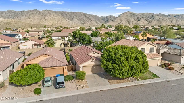 an aerial view of residential houses with outdoor space and street view